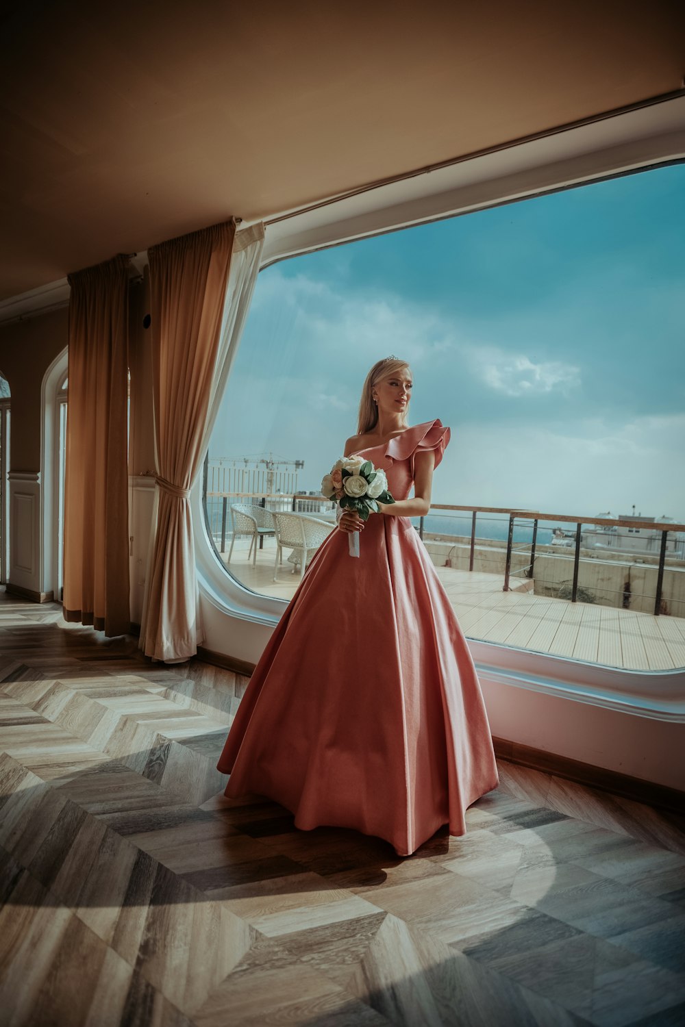 woman in red dress standing on brown wooden floor during daytime