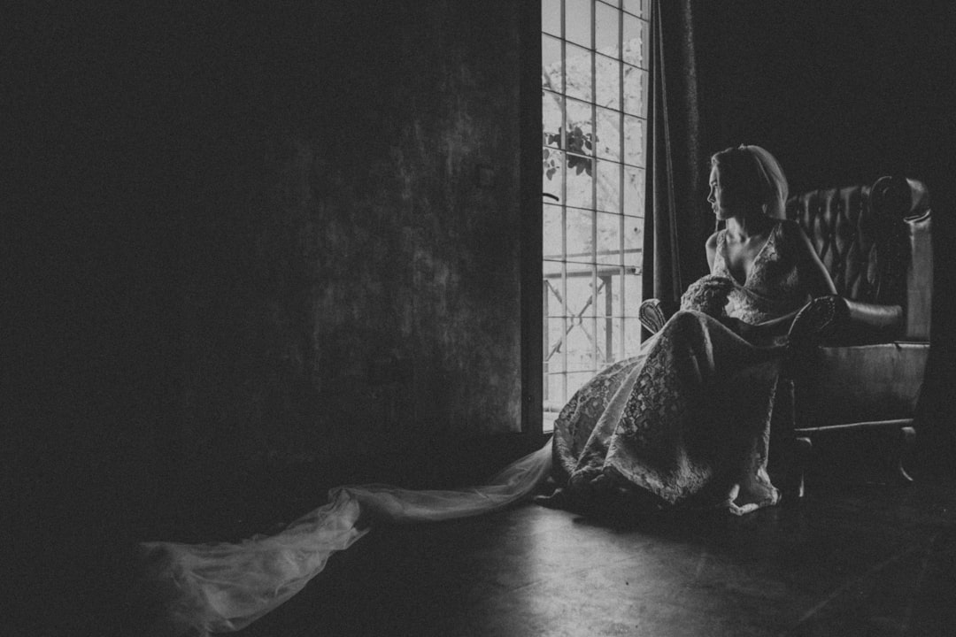 woman in black and white dress sitting on floor