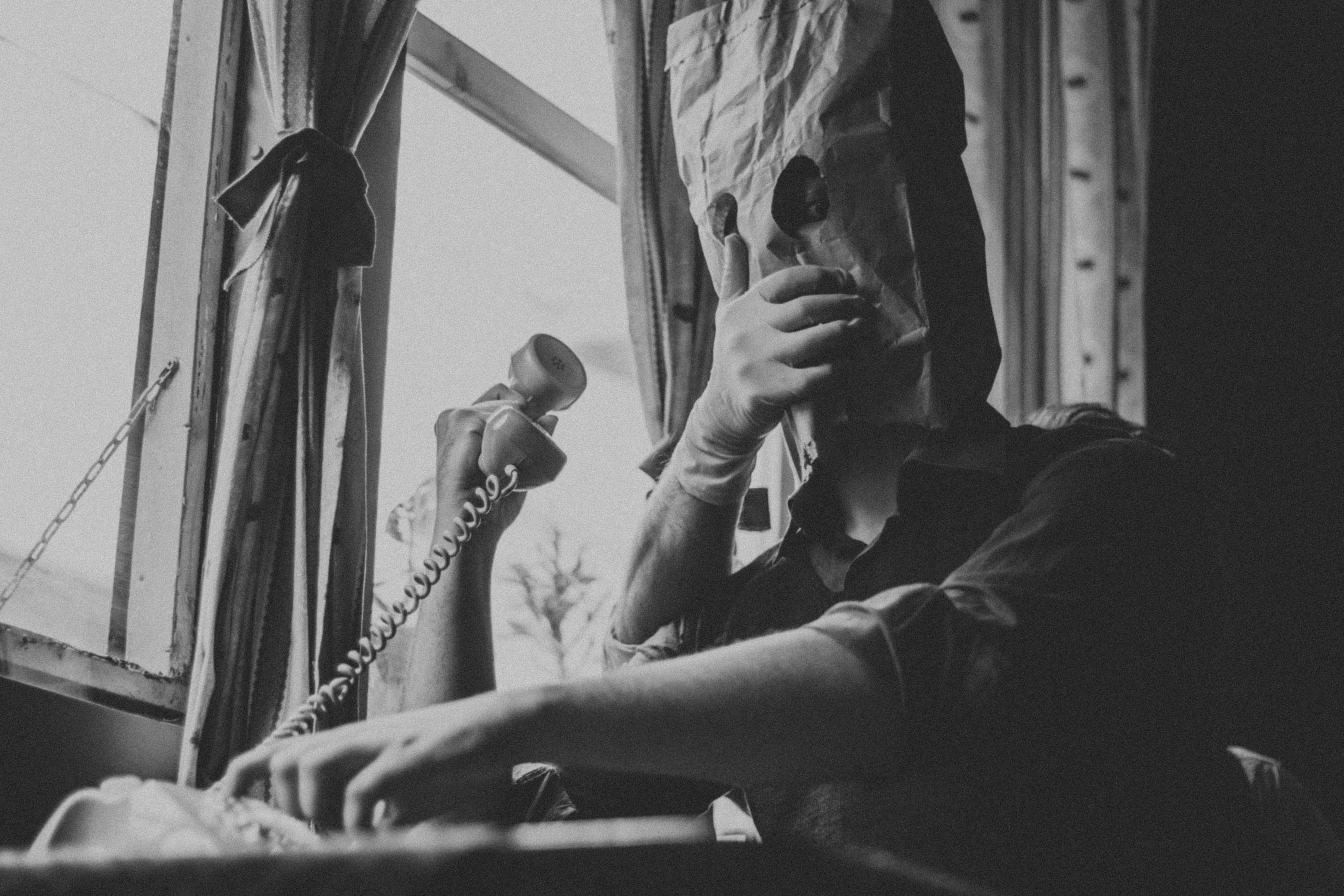 grayscale photo of man and woman holding hands