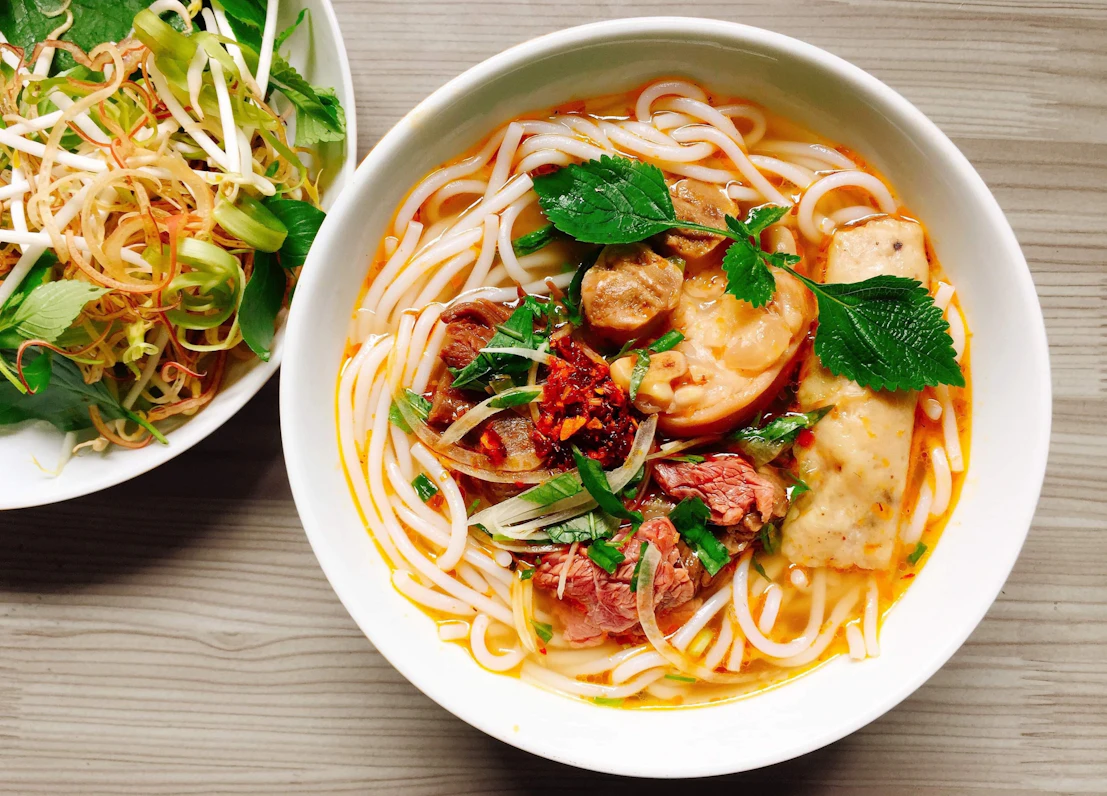 A fresh bowl of authentic Cao Lau noodles served with fresh greens and pork in Hoi An