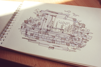 Close-up of architectural sketches with natural elements intertwined.