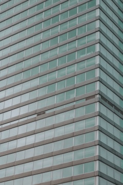 Sleek commercial building facade with durable aluminum window systems reflecting the city skyline.