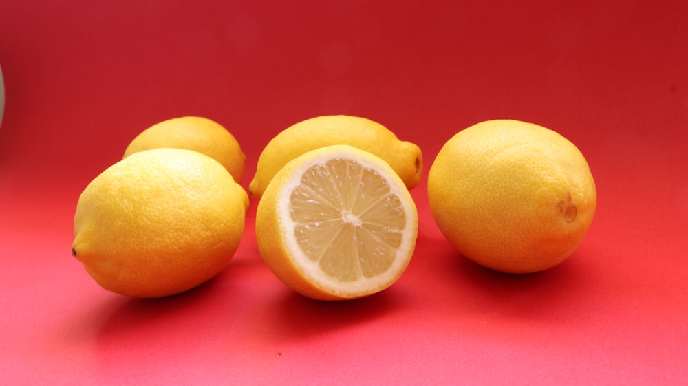 yellow lemon fruit on pink surface
