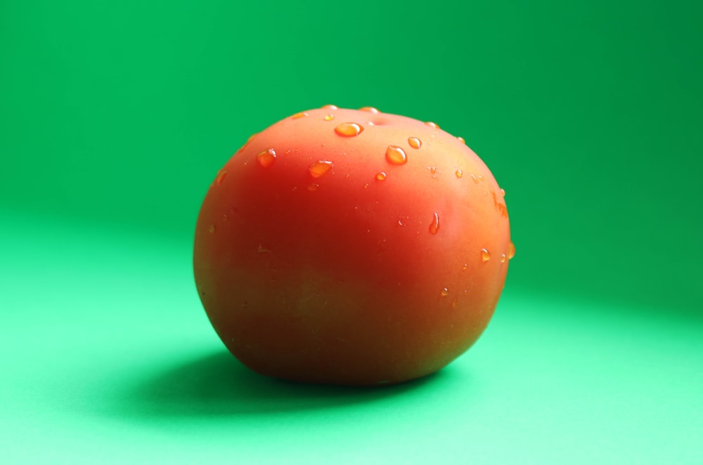 red round fruit on green surface