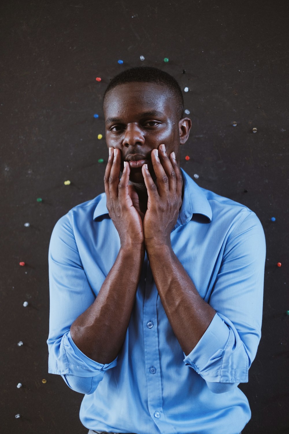 man in blue dress shirt smoking cigarette