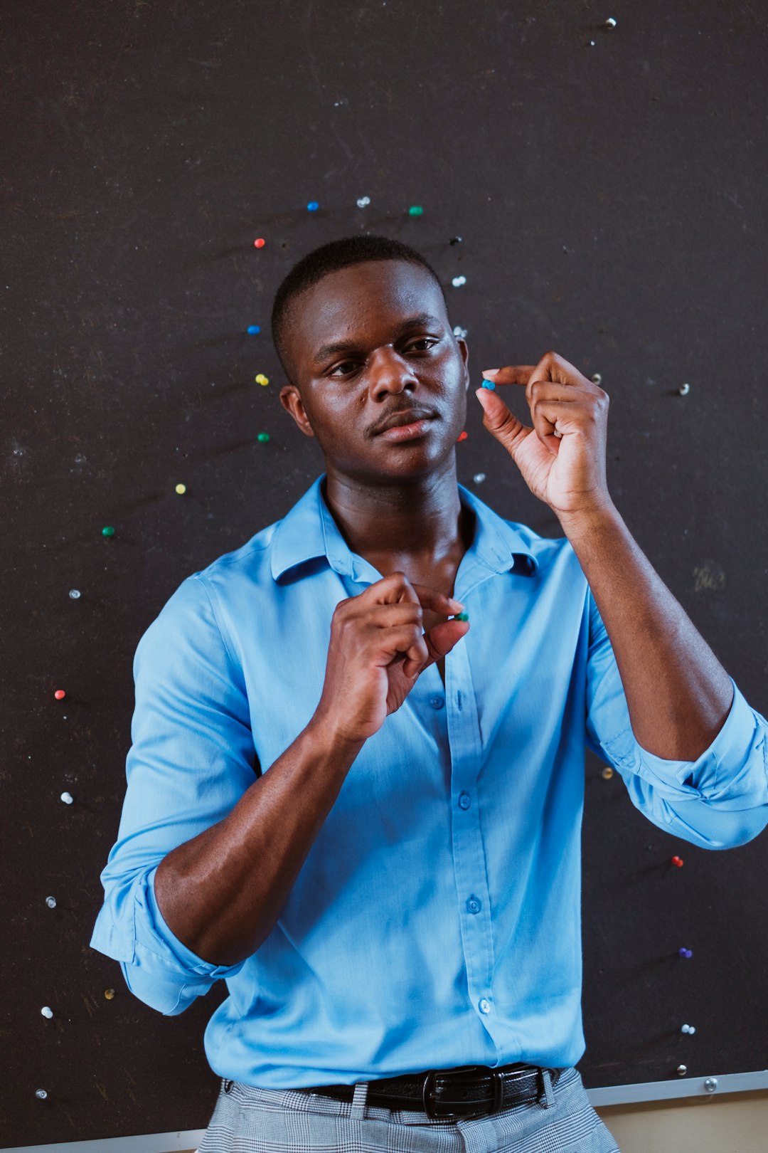 man in blue button up shirt smoking cigarette