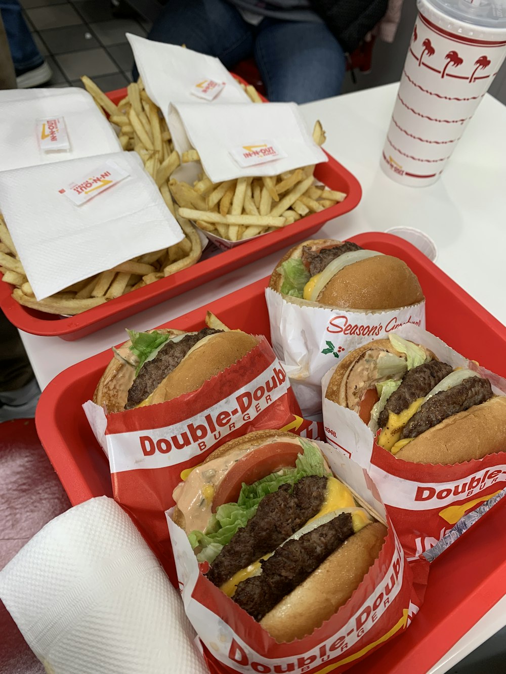 burger and fries on red plastic tray