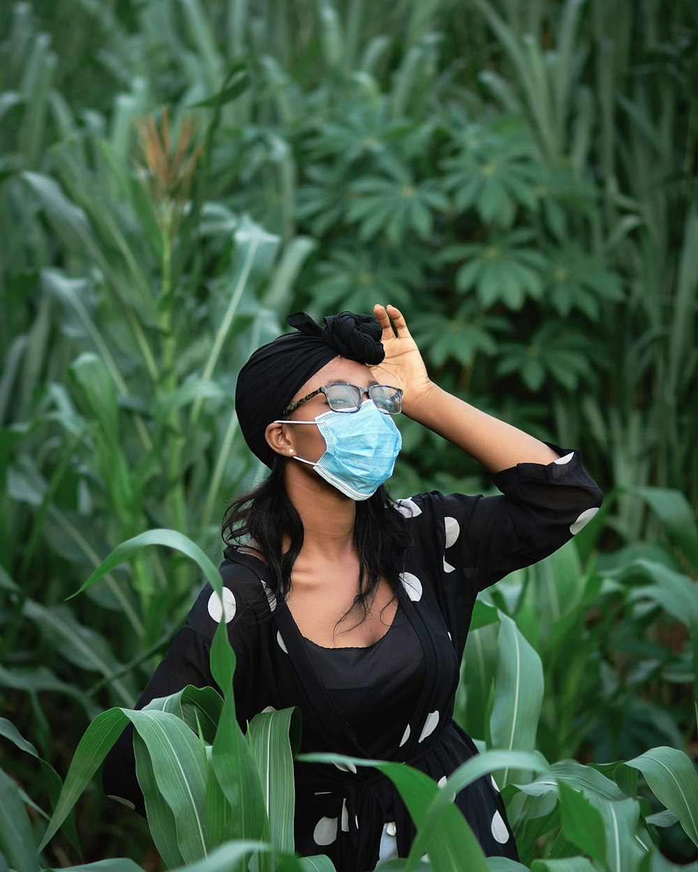 woman in black long sleeve shirt wearing blue sunglasses