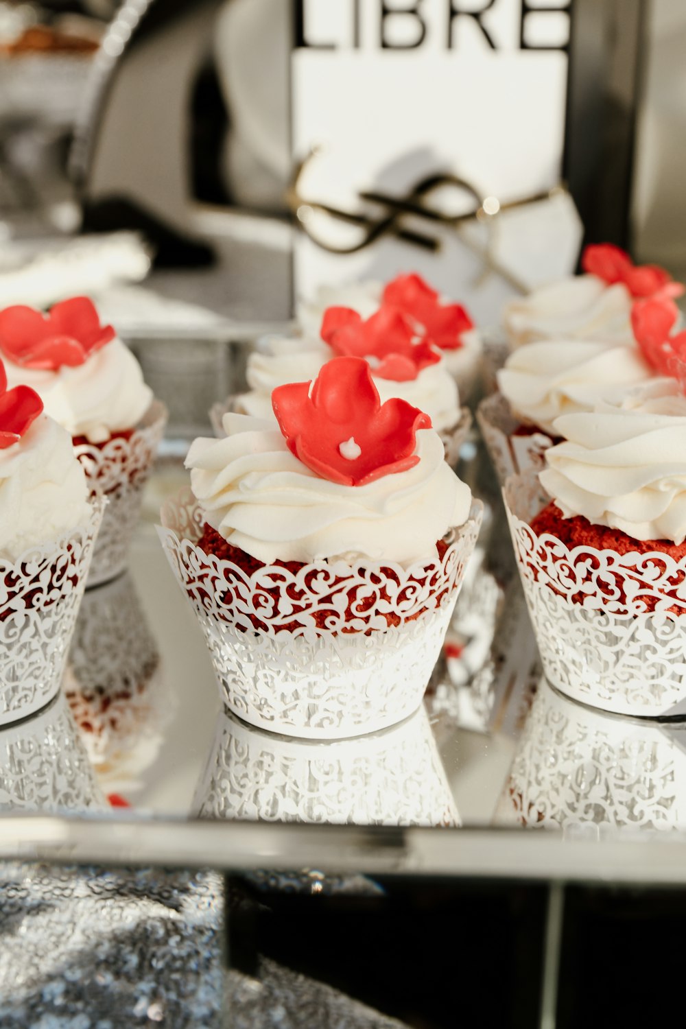 white and red cupcakes with red icing on top