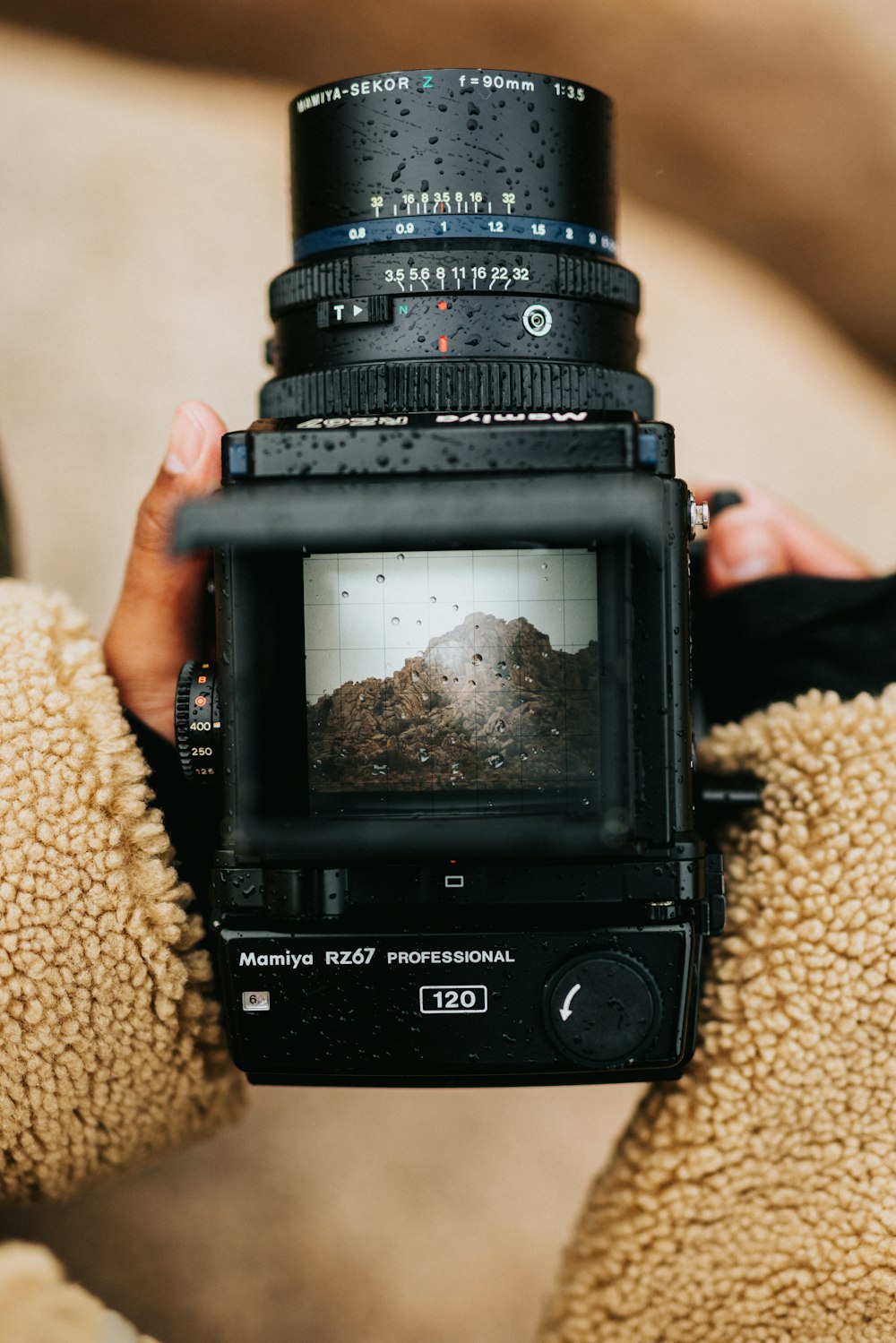 black dslr camera on brown textile