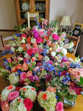 A close-up of fresh flowers blending with fashion accessories on a cozy table.