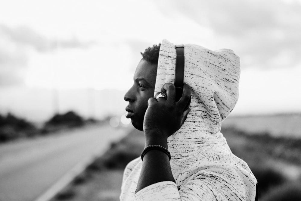 grayscale photo of woman holding her chin