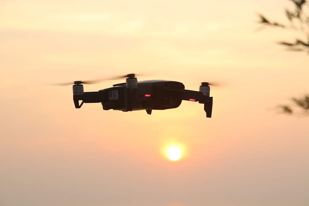 black camera on mid air during sunset