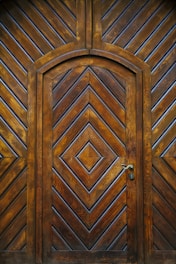 brown wooden door with silver handle