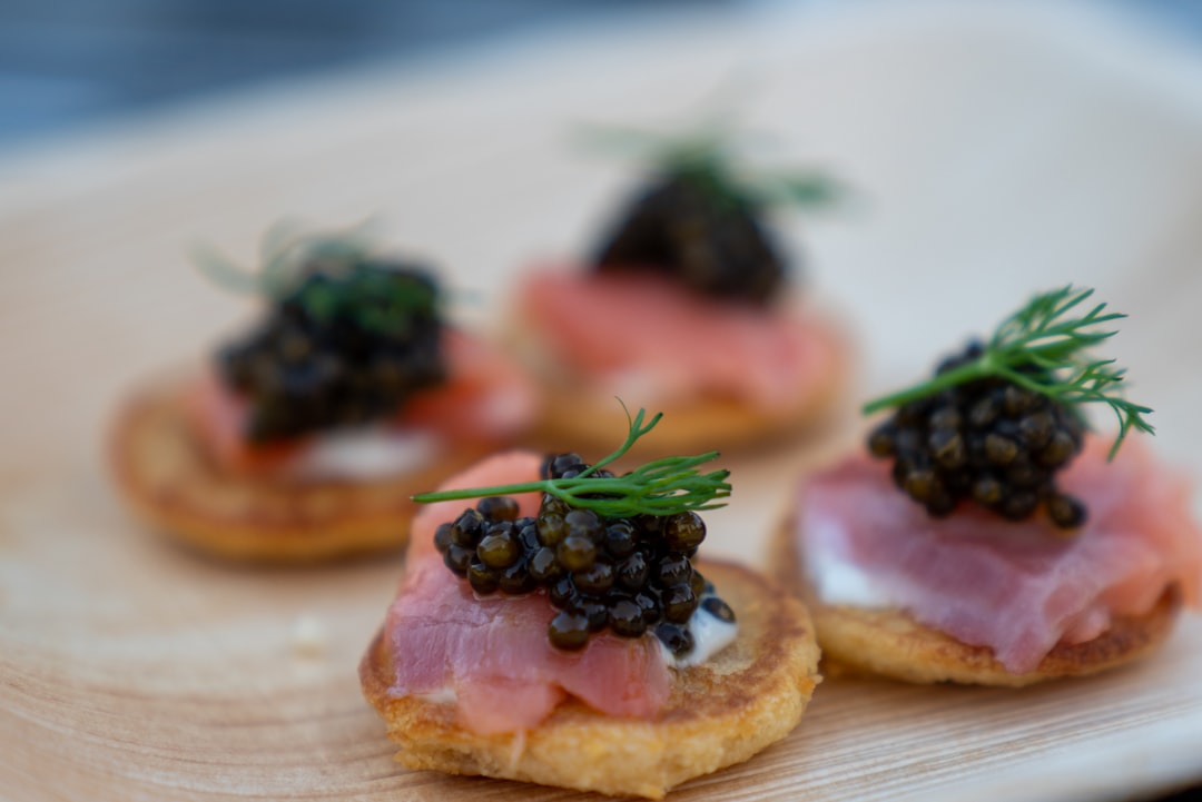 brown bread with green leaves on white ceramic plate, Caviar