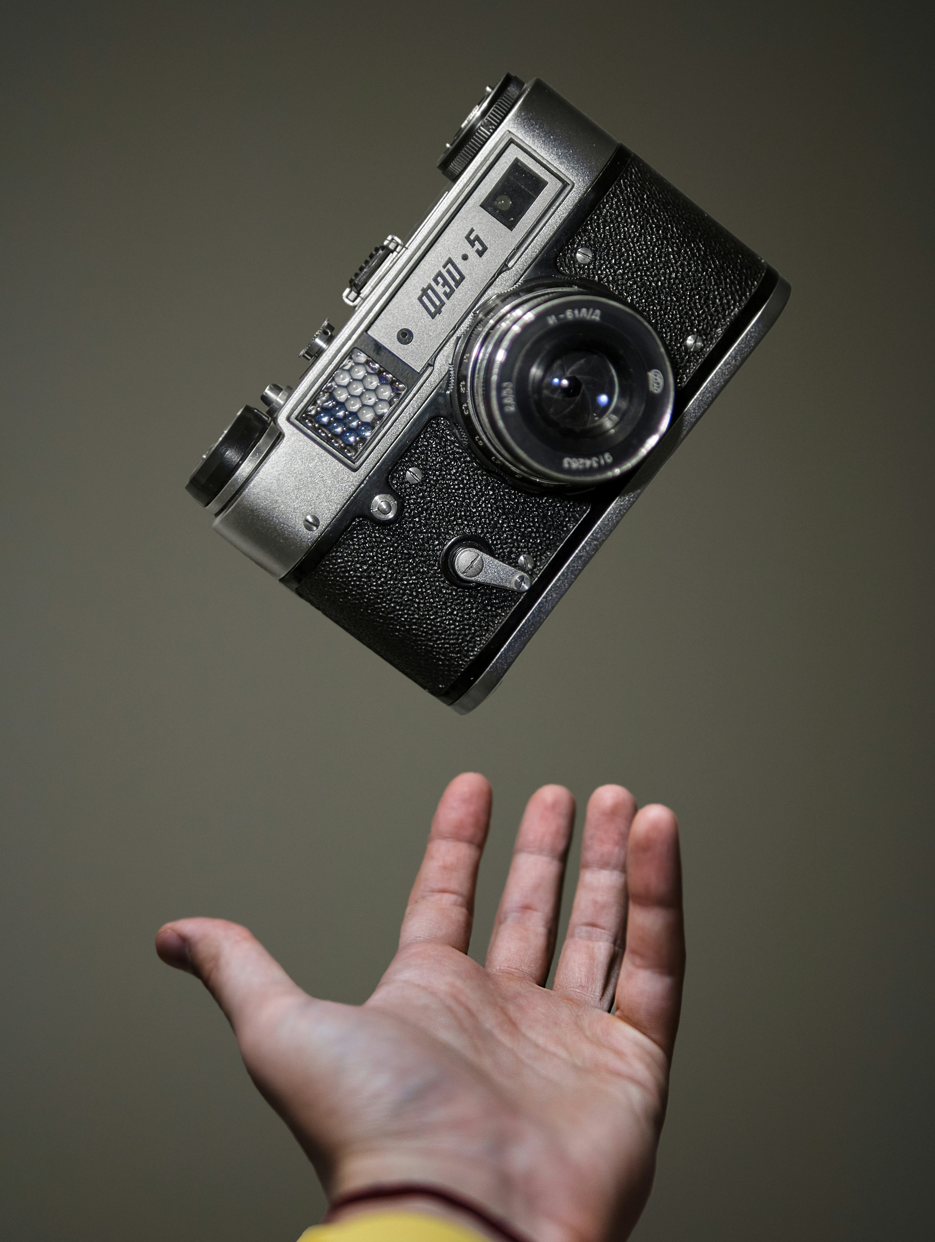 person-holding-black-and-silver-camera