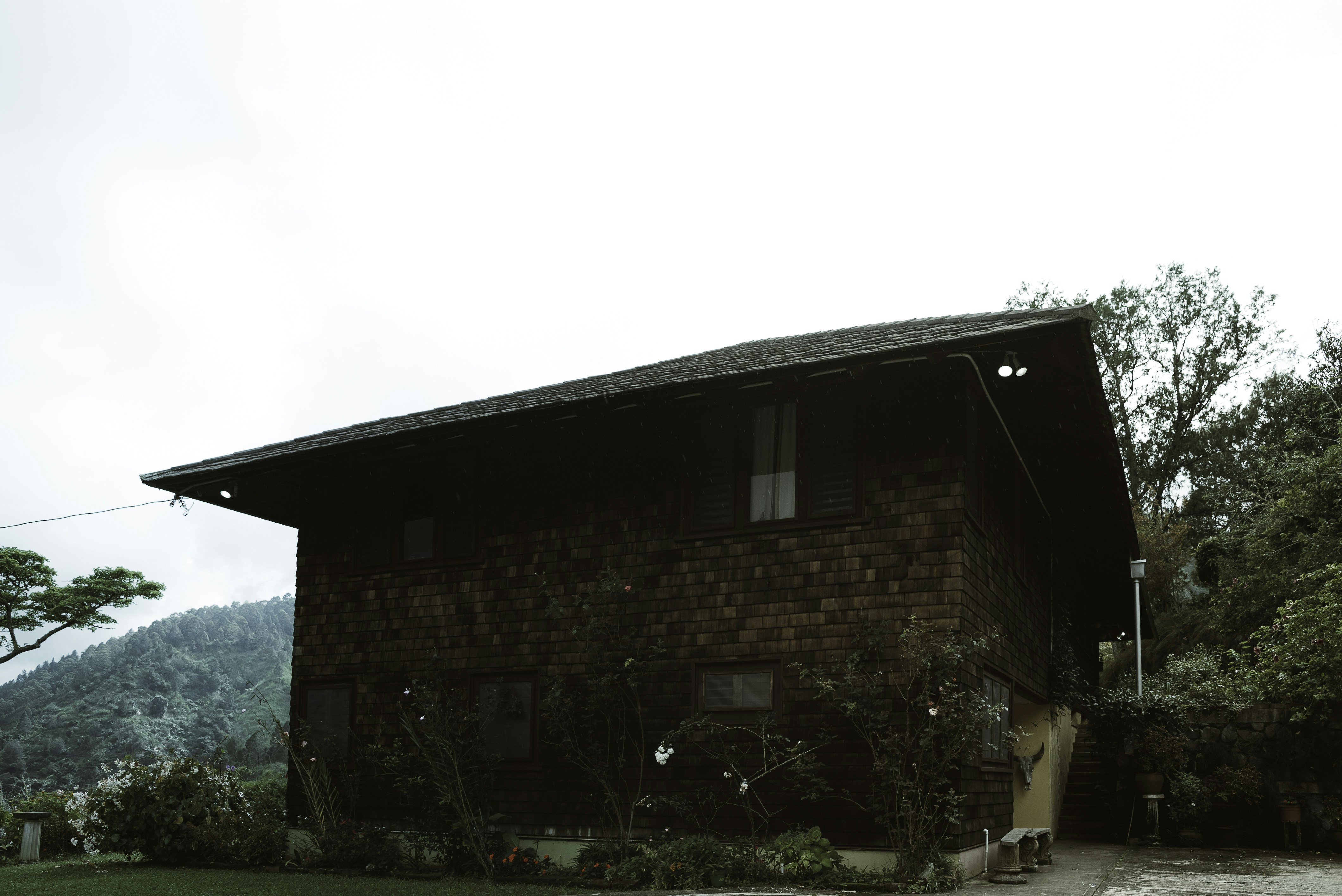 brown brick house near green grass field during daytime