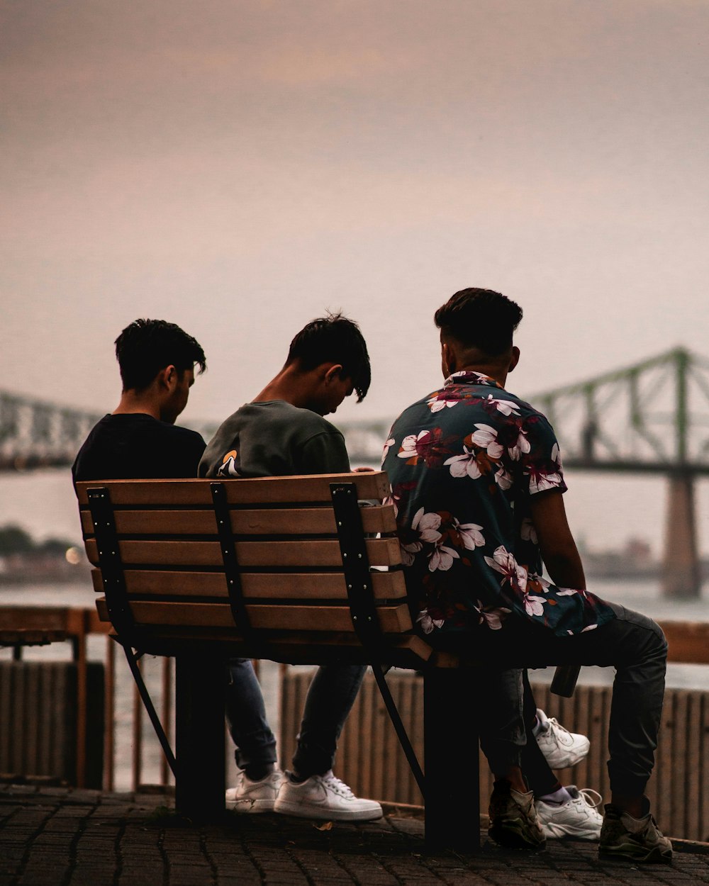 man and woman sitting on bench during daytime