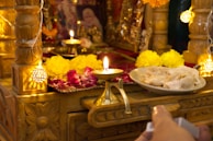 The temple’s altar adorned with fresh flowers and softly glowing candles at dusk.