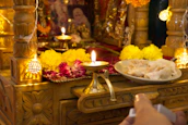 A peaceful altar with a glowing diya lamp and sacred texts arranged neatly.