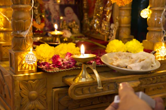 A peaceful altar setup with statues, candles, and fresh flowers