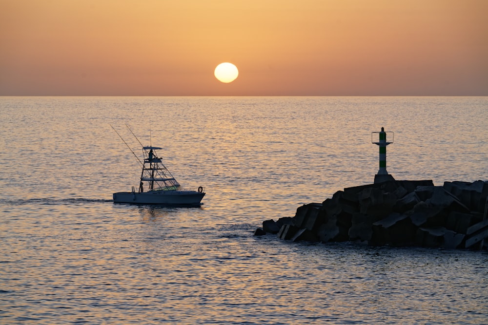 silhouette of person on boat during sunset