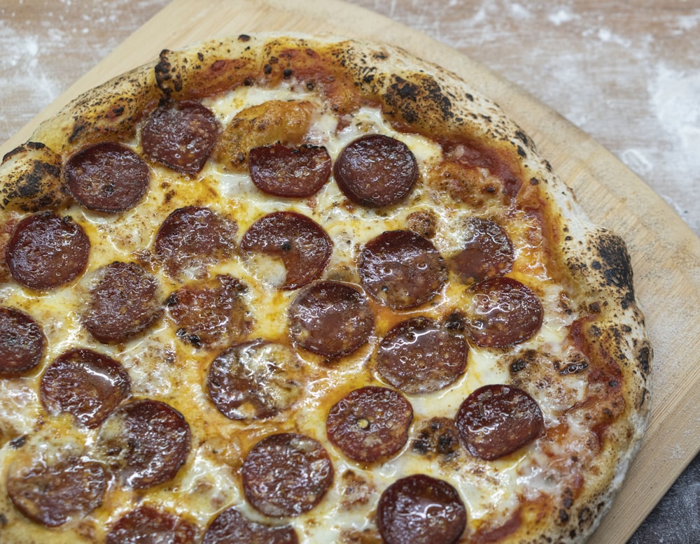 pizza with cheese and green leaves