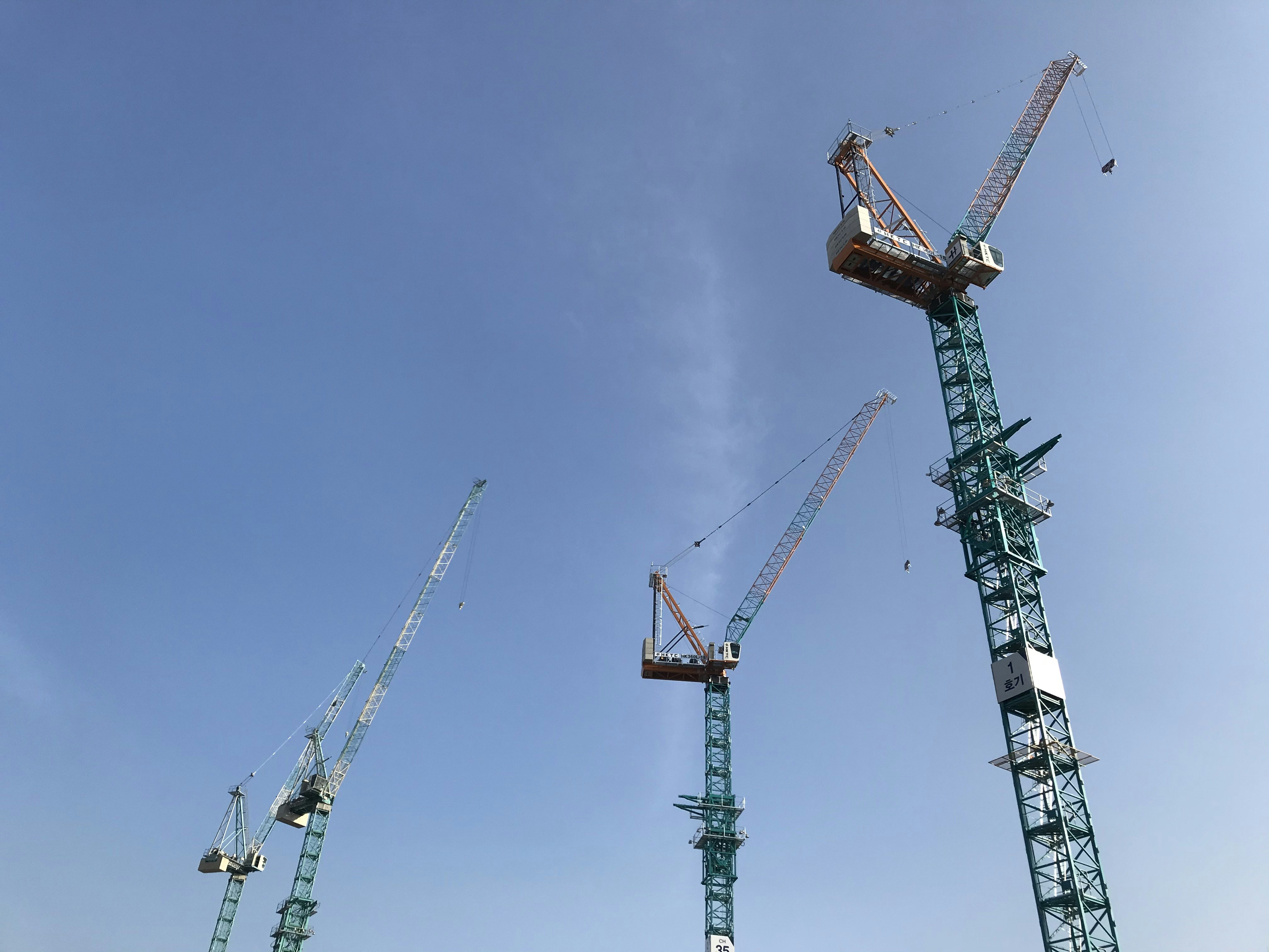 orange and gray crane under blue sky during daytime