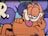 A colorful mural featuring a cartoon cat with orange fur and black stripes. The cat is depicted with a relaxed expression, its eyes half-closed, and its tongue playfully sticking out. The background incorporates purple and blue hues with bold outlines.