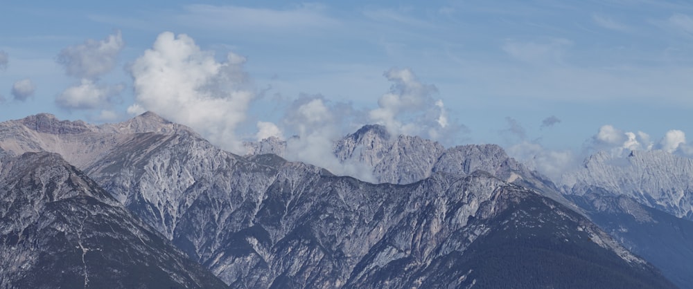 gray and white mountain under white clouds during daytime