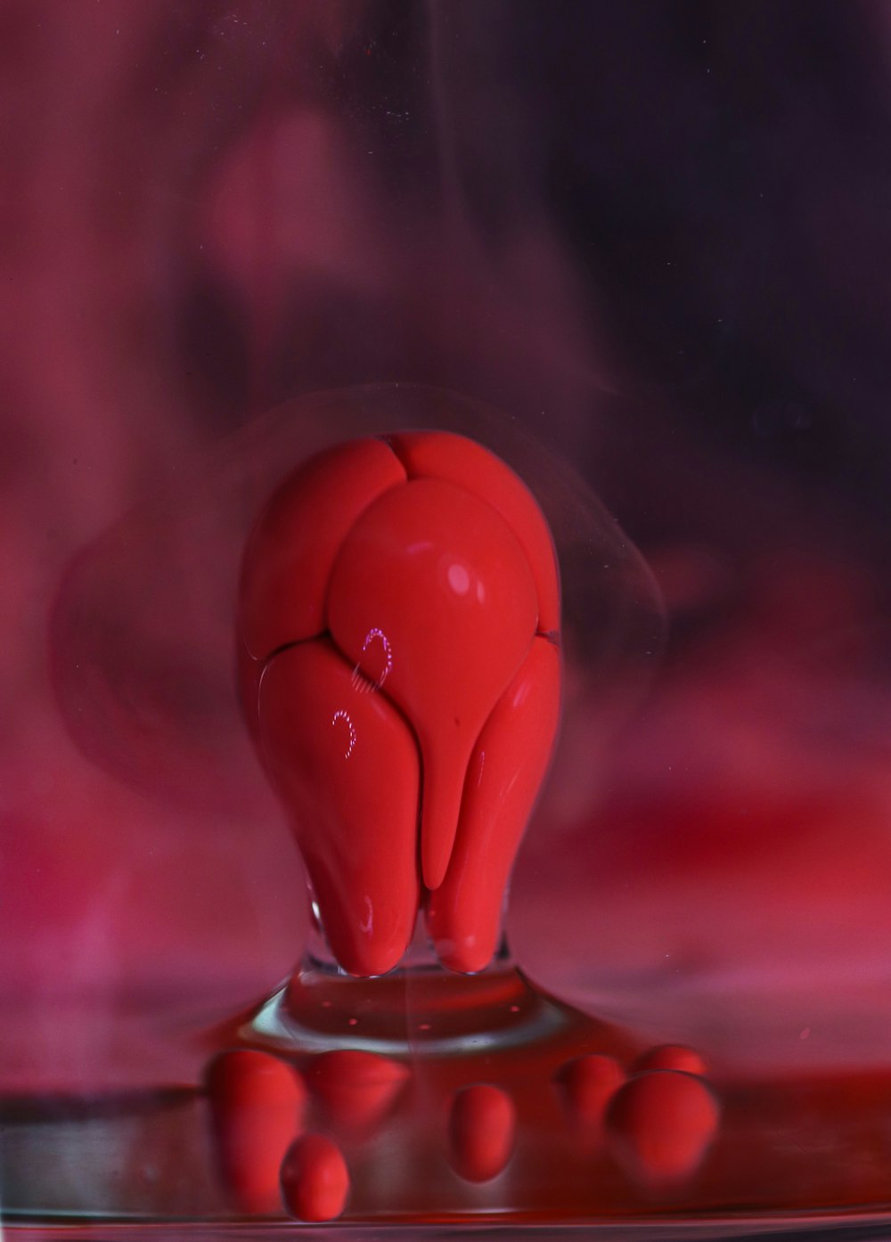 red heart figurine on pink surface