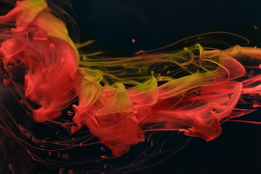 A vibrant splash of cyan, magenta, yellow, and black ink blending in abstract shapes.