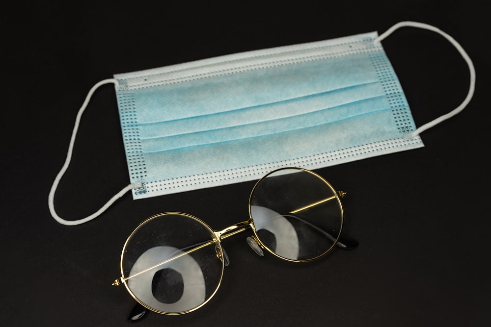 silver framed eyeglasses on black table