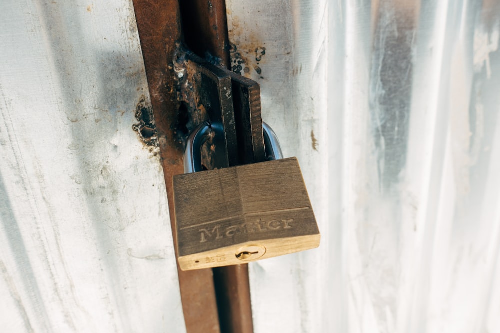 brown padlock on brown wooden post