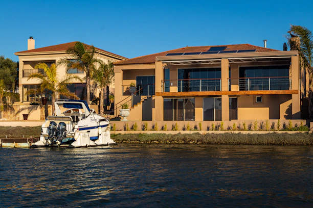 A modern Florida home showcasing sleek impact windows and doors under bright sunlight.