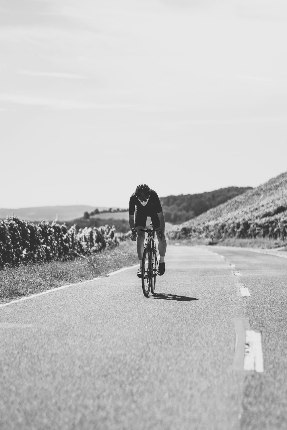 man in black jacket riding bicycle on road during daytime