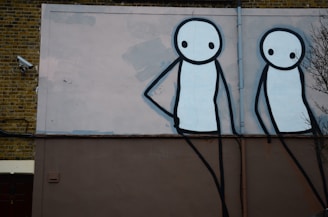 Night vision security camera still showing two figures loitering suspiciously near a residential door