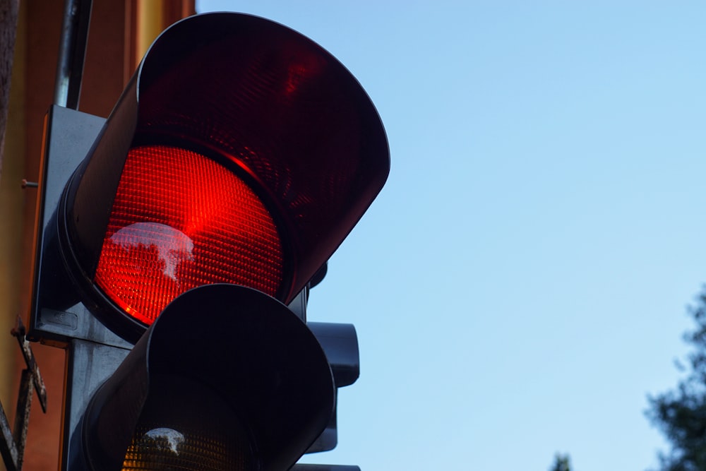black traffic light with red light