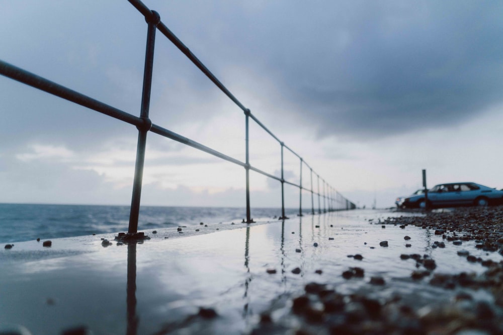 brown metal bridge over the sea during daytime