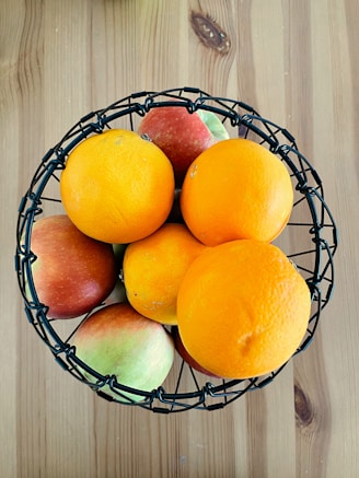 orange fruits on black metal fruit basket