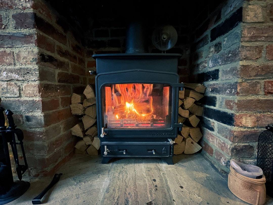  black wood burner near brown brick wall stove