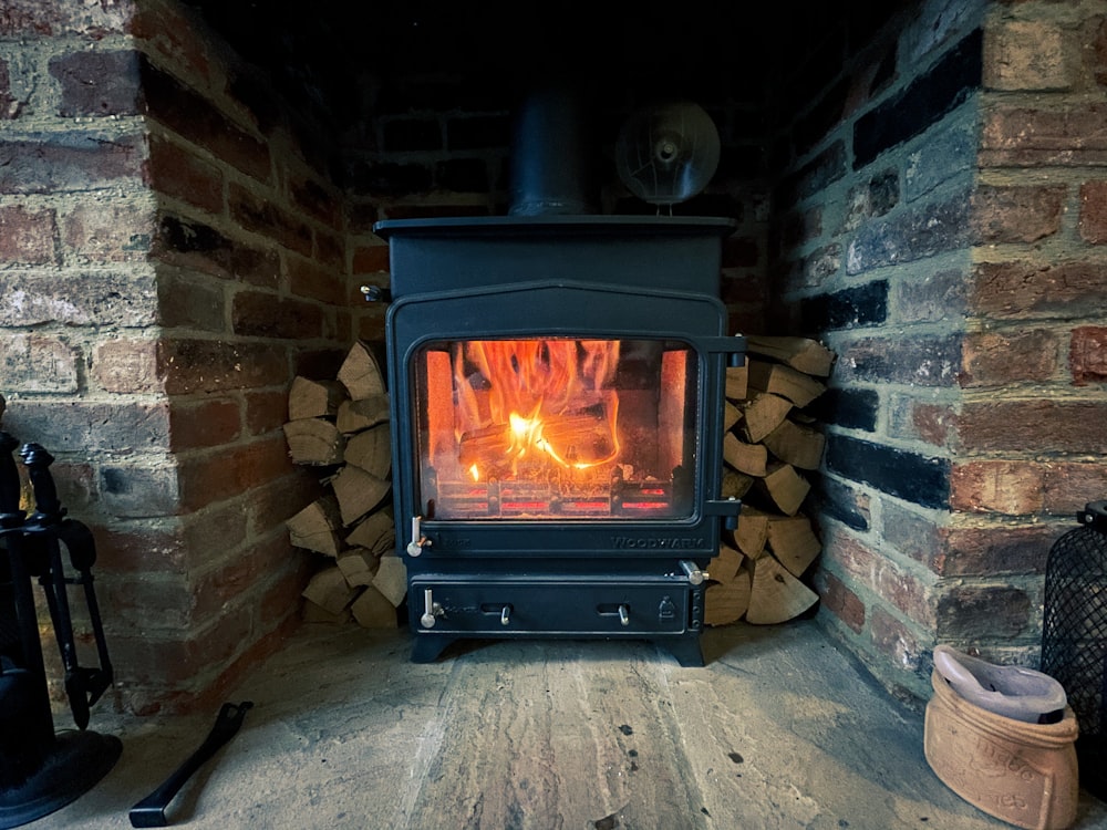 black wood burner near brown brick wall