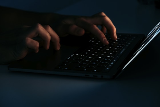 person using black laptop computer