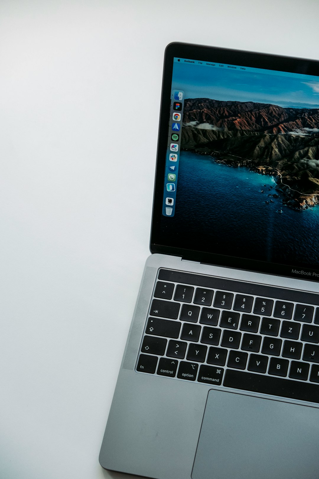 macbook pro displaying blue and white wallpaper