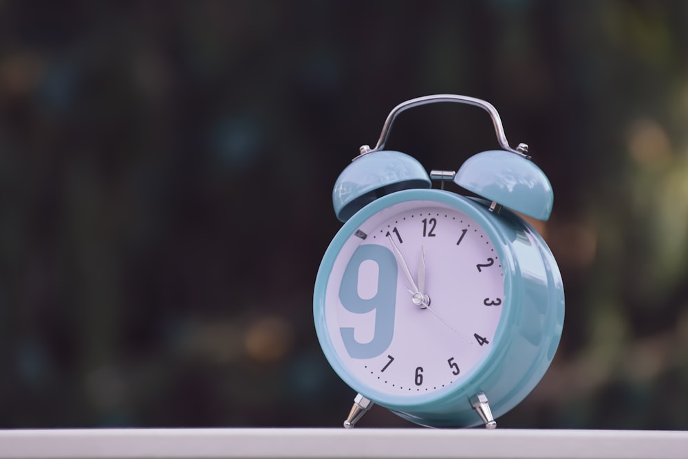 blue and white alarm clock at 10 00