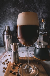 clear wine glass with brown liquid