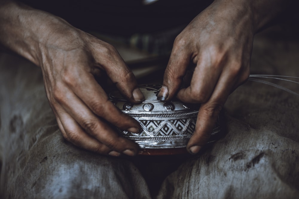 person holding silver and black ring