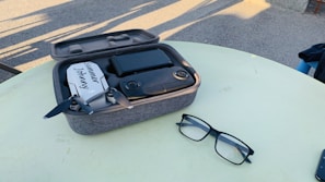 Close-up of sleek FPV goggles resting on a wooden table with soft natural light