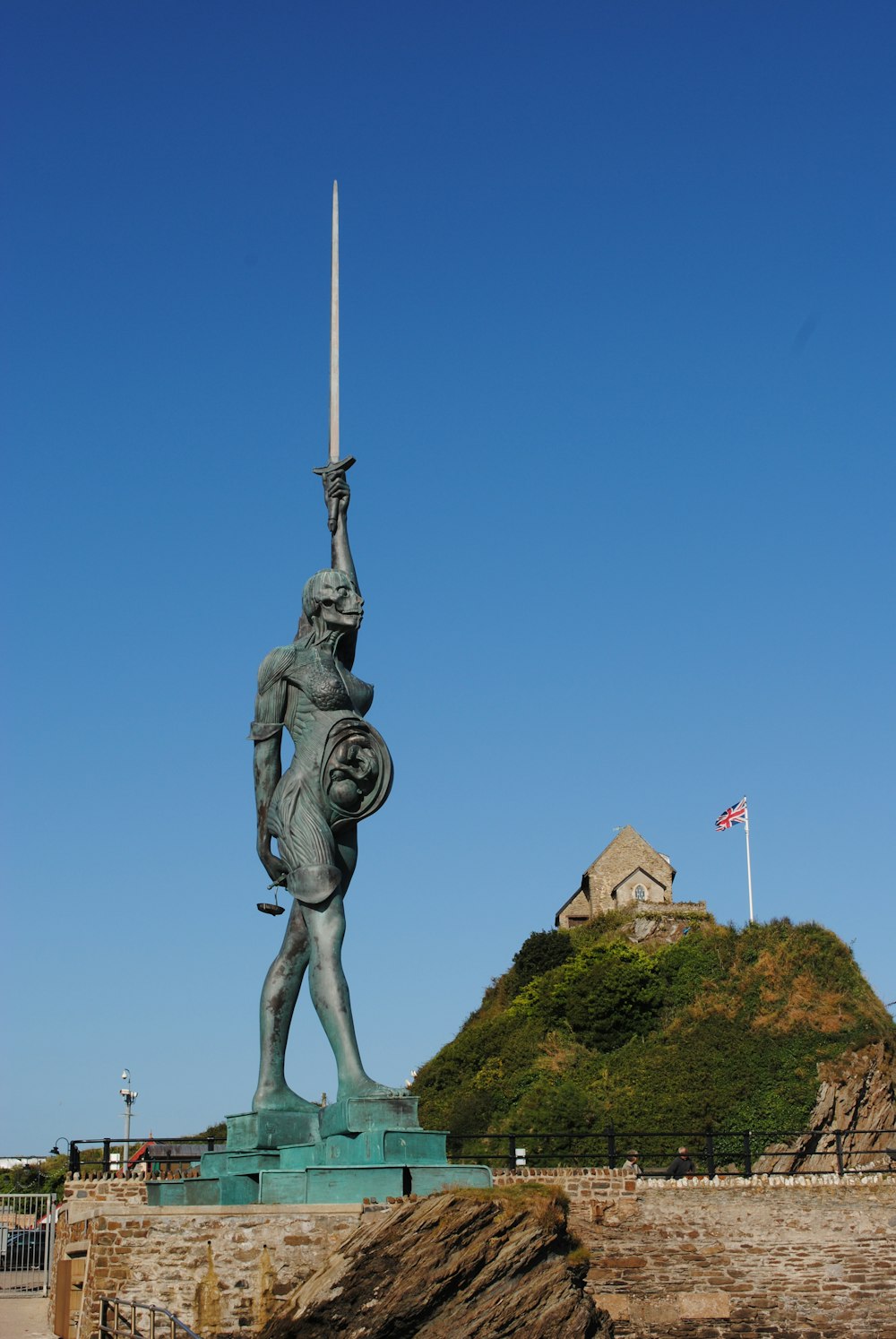 statue of man on top of mountain