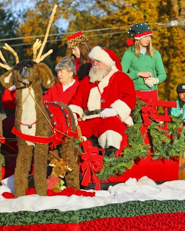 Rotary Club volunteers dressed in holiday gear helping guide the sleigh through a bustling neighborhood.